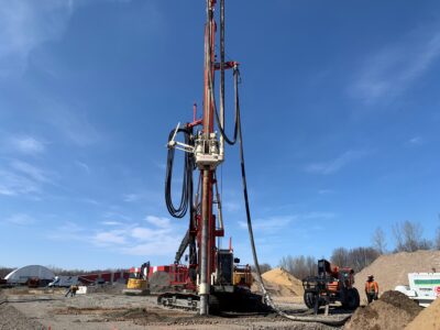 Large machine driving piles into ground