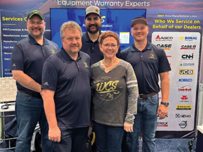 Warranty Consulting Services owner Barb Hall and team members in company booth at CONEXPO-CON/AGG 2023 in Las Vegas