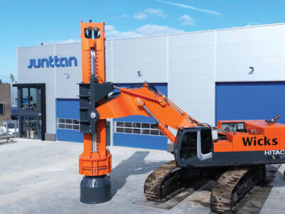 Heavy equipment vehicle with compaction tool installed