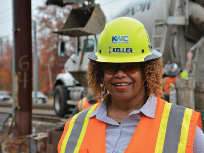 Jo-’Anthion Harris smiling for camera wearing safety hat, glasses and vest