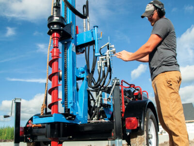 Contractor operating a hydraulic earth drill
