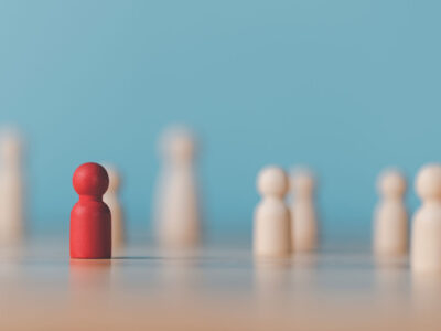 Wooden chess pieces and one red one