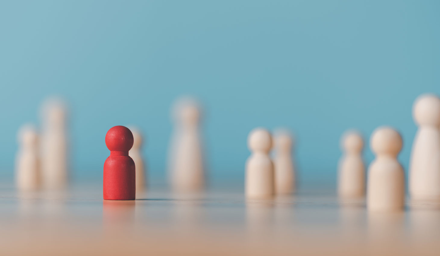 Wooden chess pieces and one red one