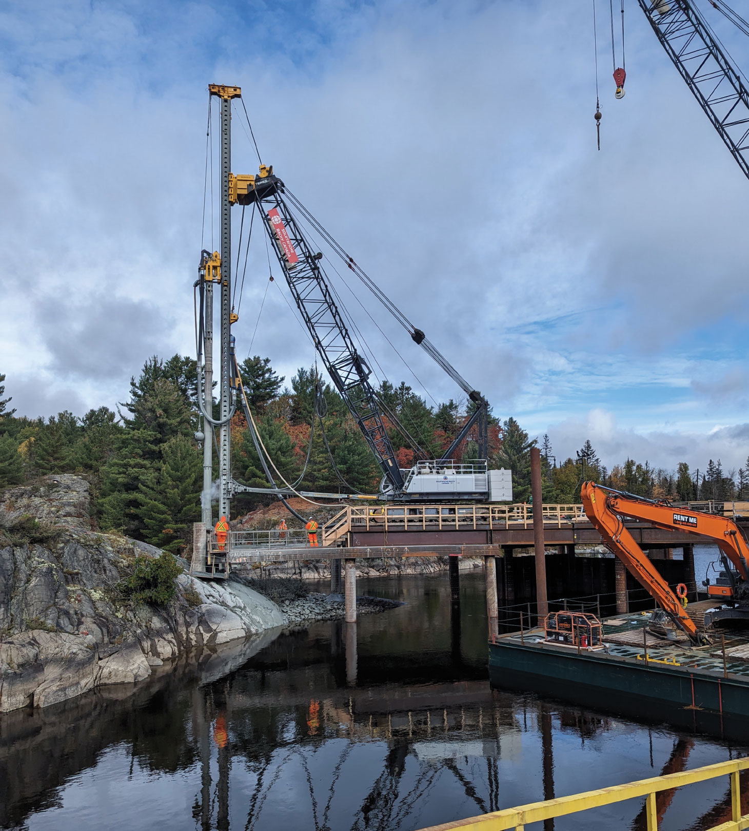 Heavy equipment driving piles at Nairn Falls generating system