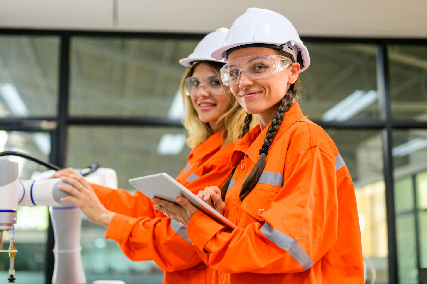 Two women wearing PPE equipment, smiling