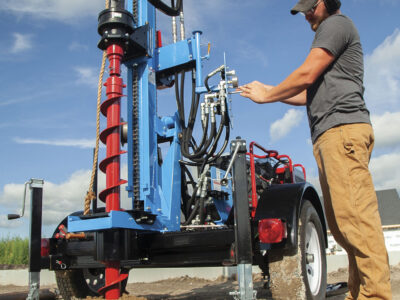 Man operating retrieving sample with auger