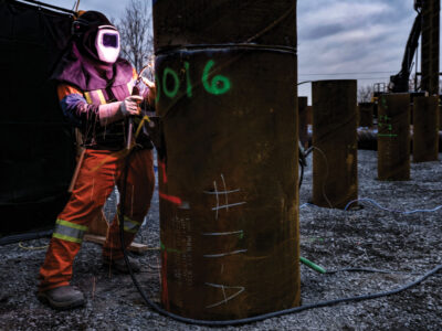 Welder working on large pipe