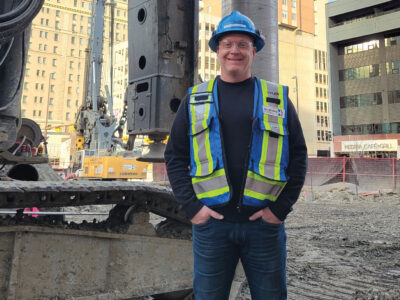 Tyler Wilbur on job site wearing PPE and big smile