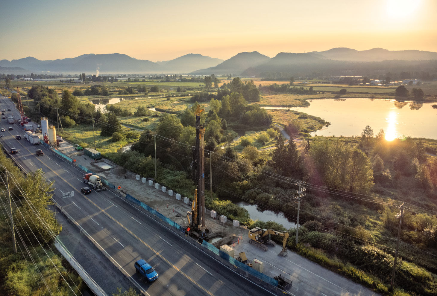 Aerial view of construction site with sun setting in background