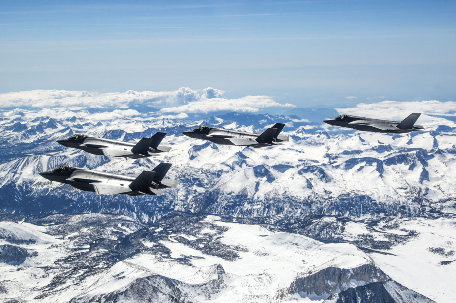 airplanes flying above snow-covered mountains