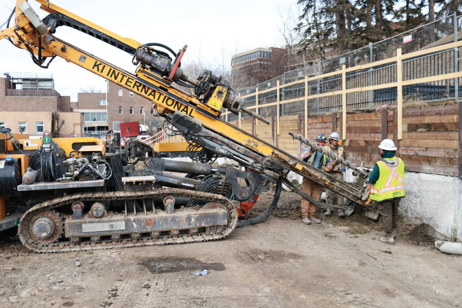 Workers gathered around piling rig