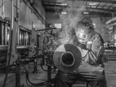 Welder performing a weld to a pile shaft