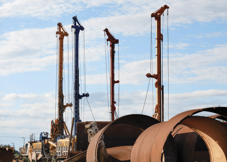 Row of pile driving rigs