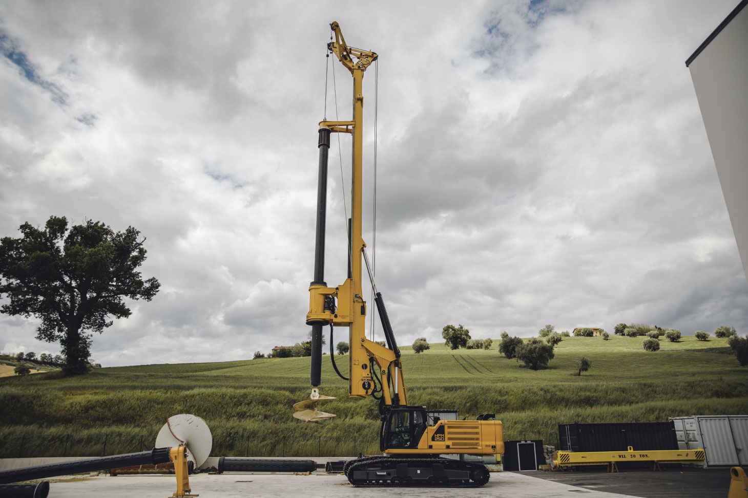 Side profile of HPM250 drilling rig with cloudy sky in background