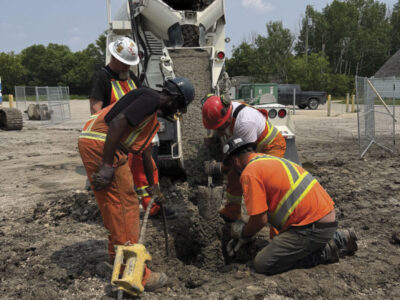Jobsite workers pouring concrete