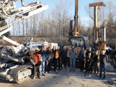Staff photo in front of heavy equipment