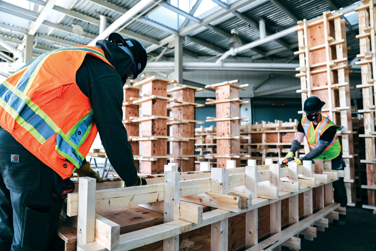 Two constructions workers on job in high-vis vests and hard hats