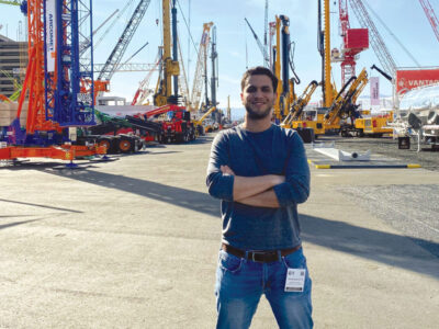 David Zanchetta posing in front of heavy machinery