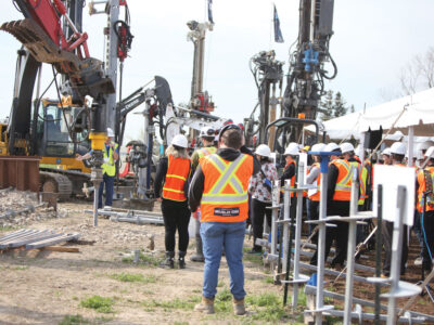Workers and heavy machinery on jobsite