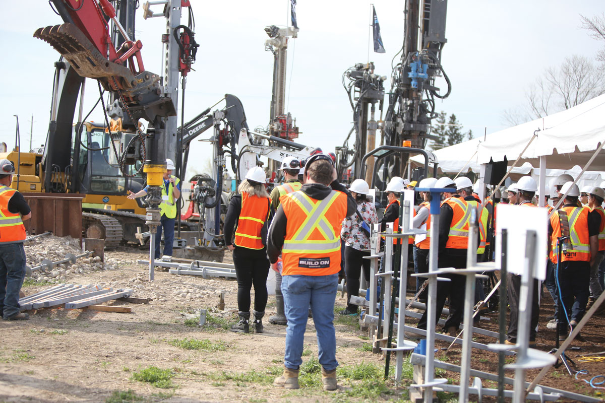 Workers and heavy machinery on jobsite
