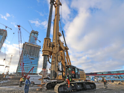 Pile driving rig with building construction in bckground