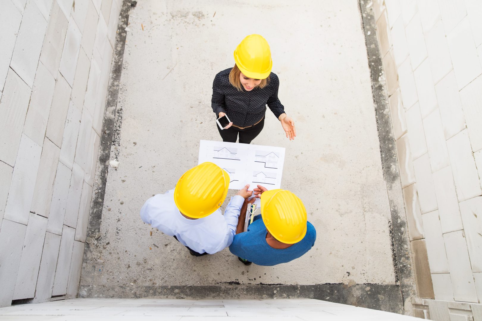 Aerial photo of three people in hardhats