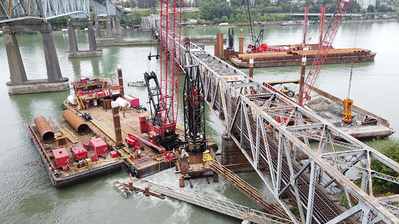 Large machinery on project site driving downstream pile and excavating sand