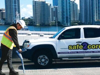ProStar worker with electromagnetic wand in hand and Safe2core truck in background