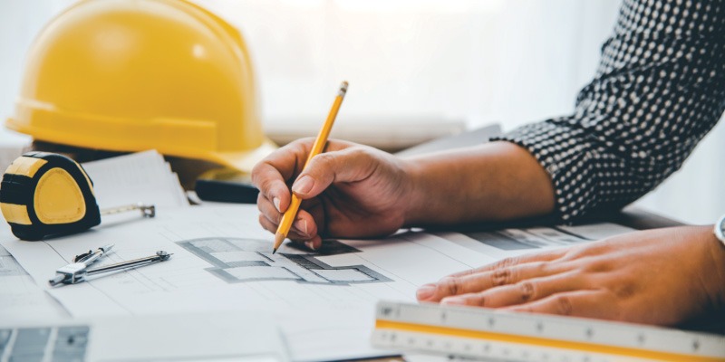 Man with pencil and architectural designs