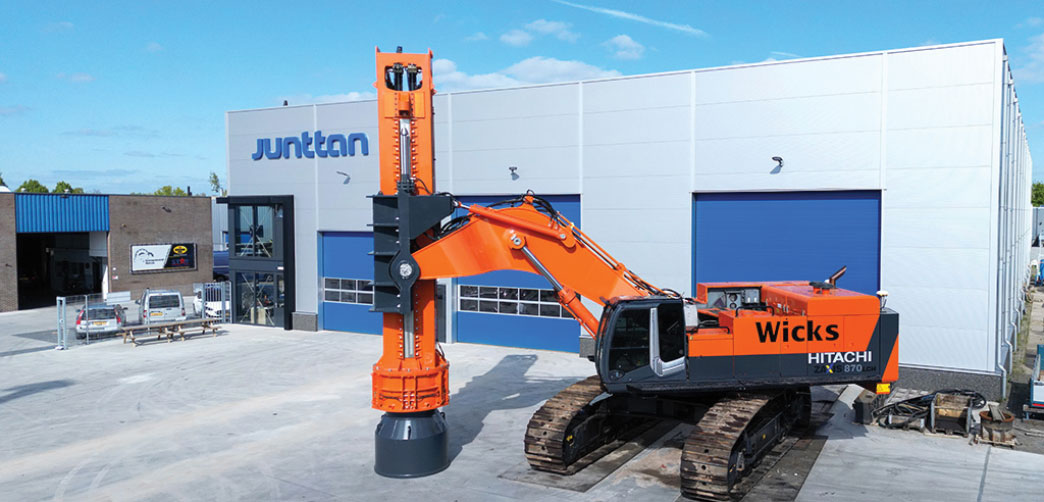 Heavy equipment vehicle with compaction tool installed