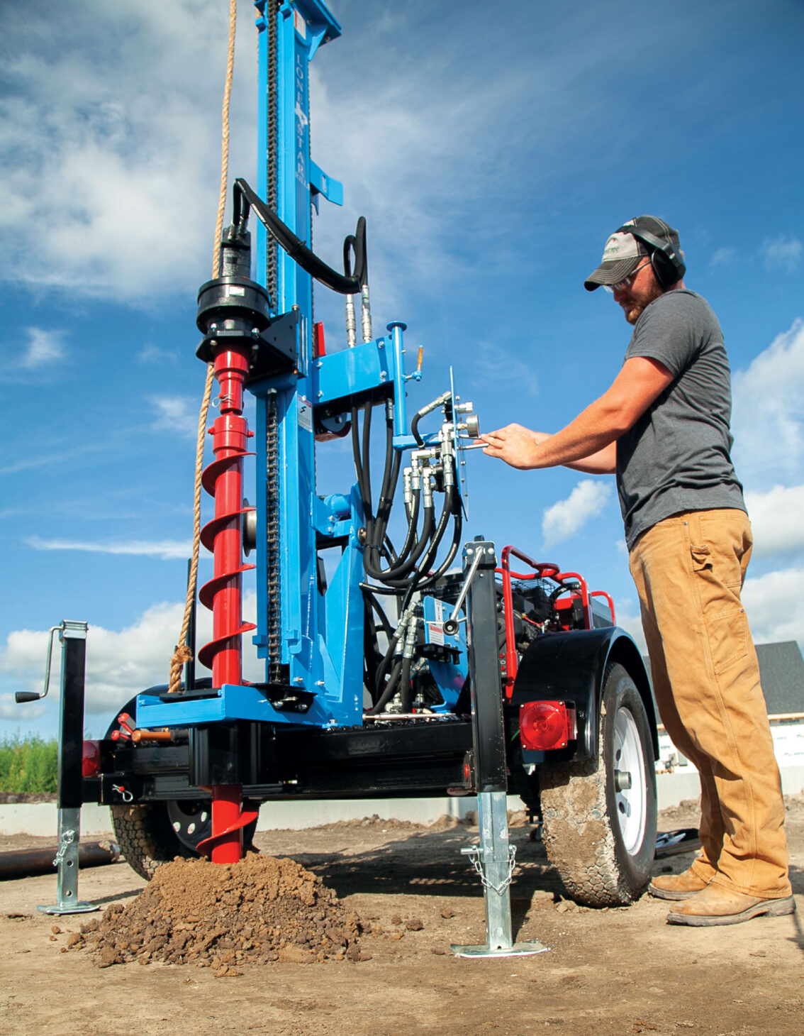 Contractor operating a hydraulic earth drill