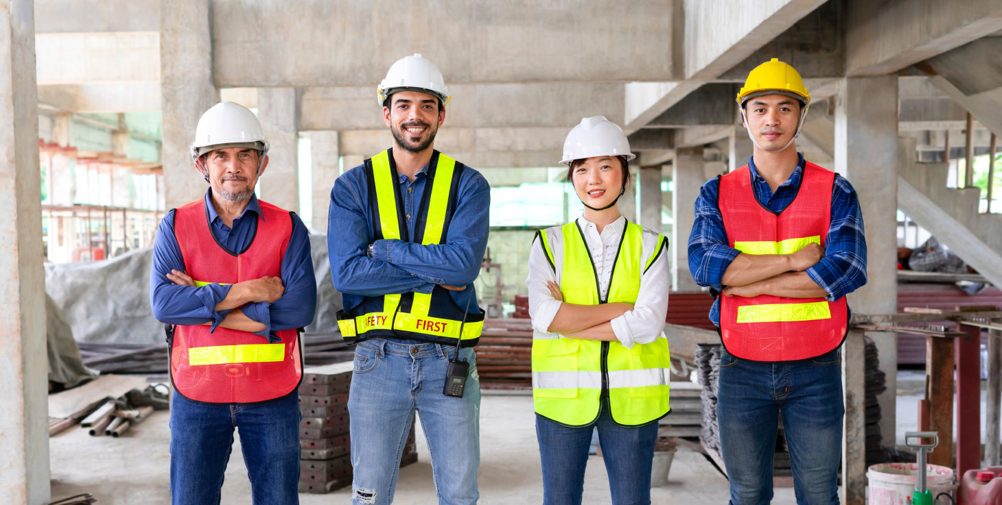 Small, diverse group of construction workers smiling for photo