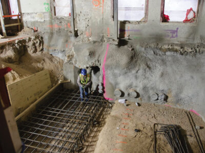 Worker in dug up building foundation