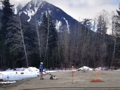 Worker operating Terraprobe with mountain landscape in background