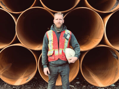 Anthony Calnan posing for photo with helmet tucked under arm