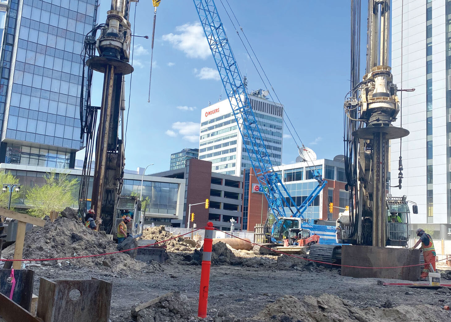 Foundation construction with commercial buildings in background