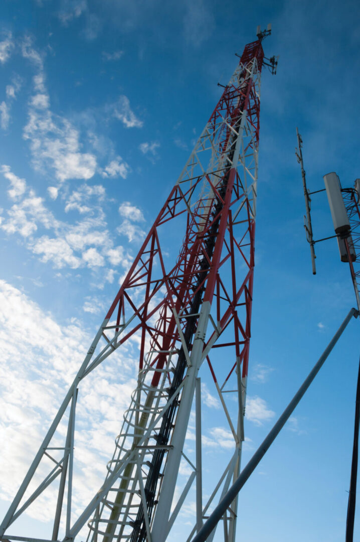 Telecommunication tower with blue sky and white clouds