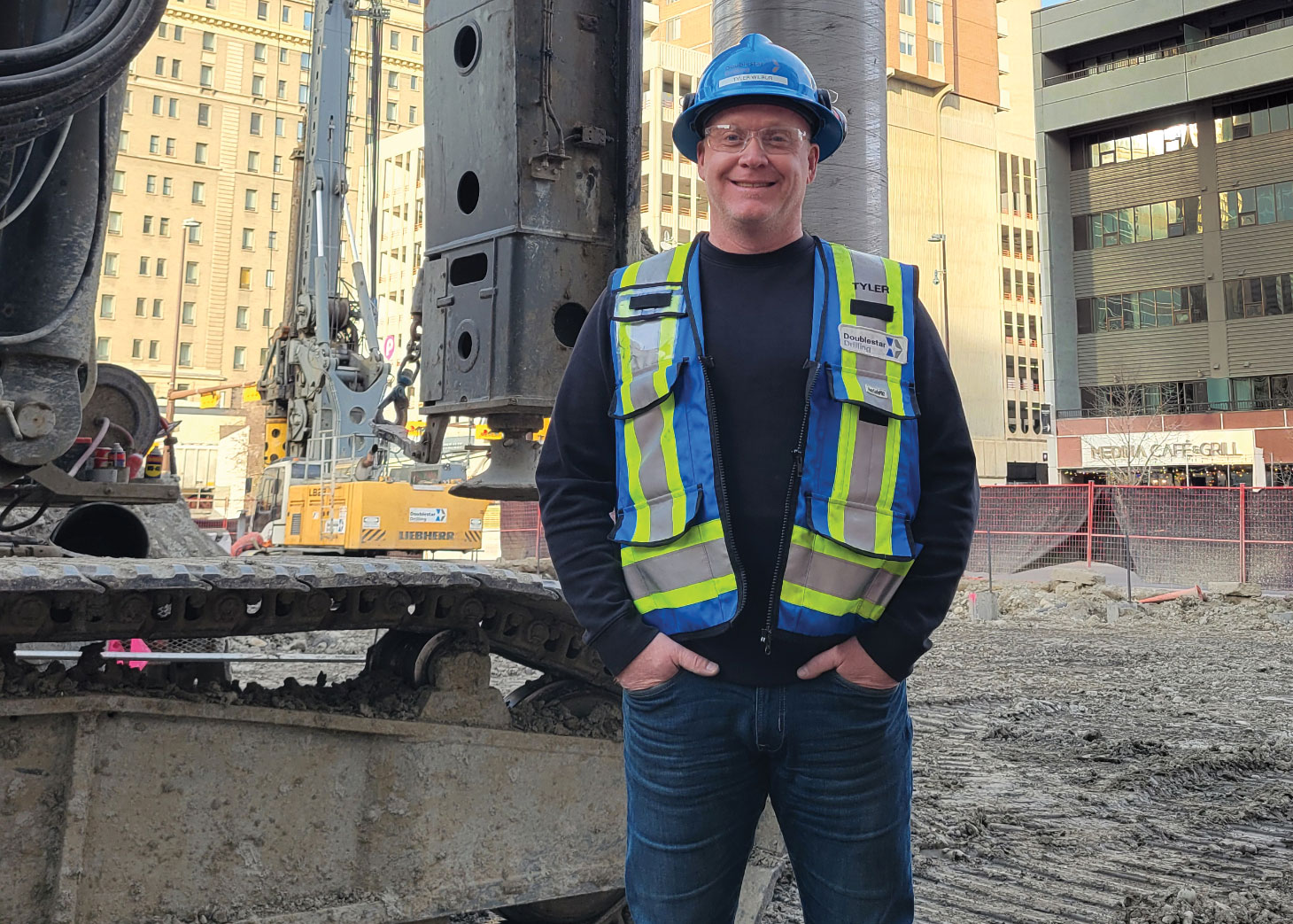 Tyler Wilbur on job site wearing PPE and big smile