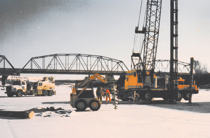 Construction with bridge in background