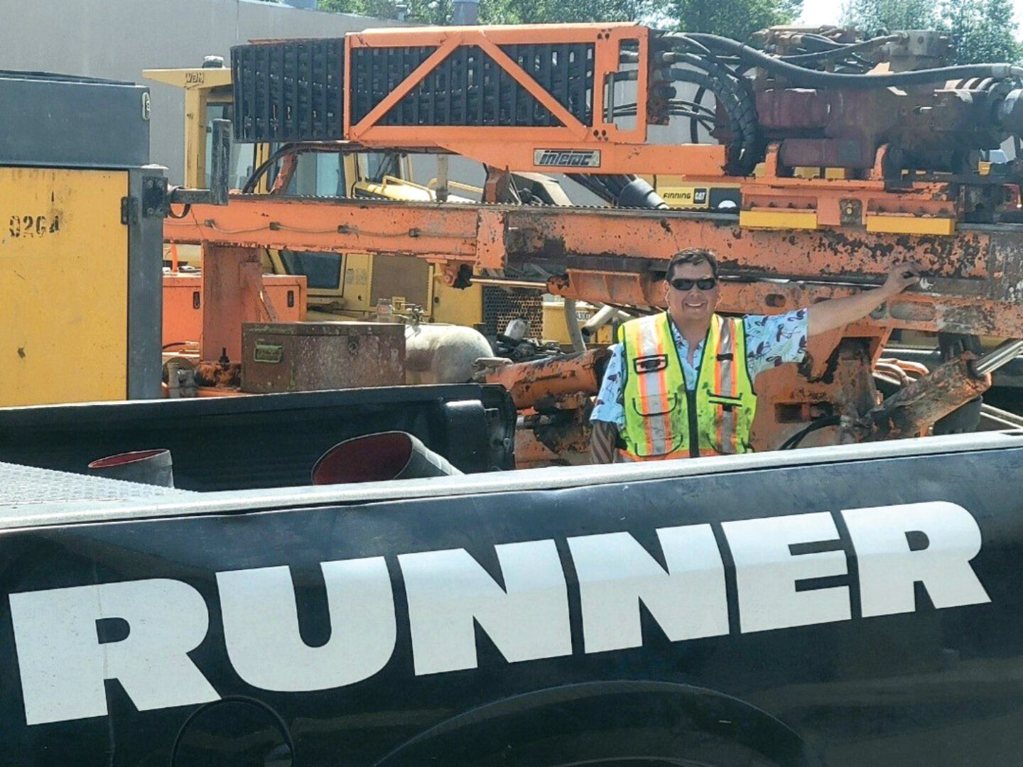 Daryl Houston posing for photo, leaning against machine