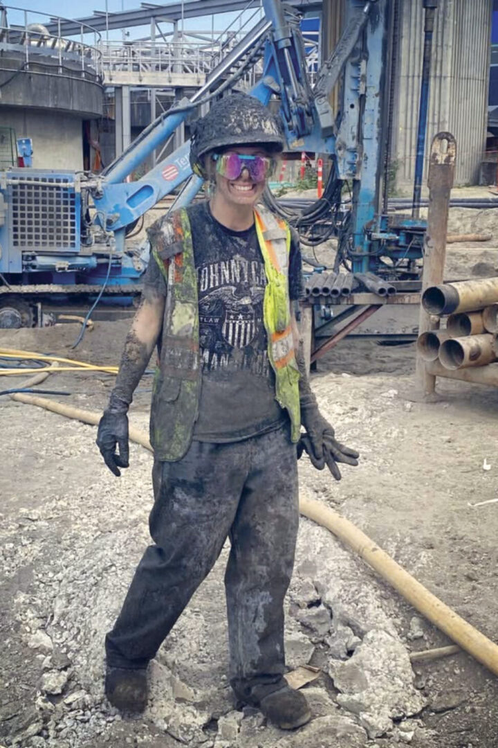 Jessica smiling, covered in muck