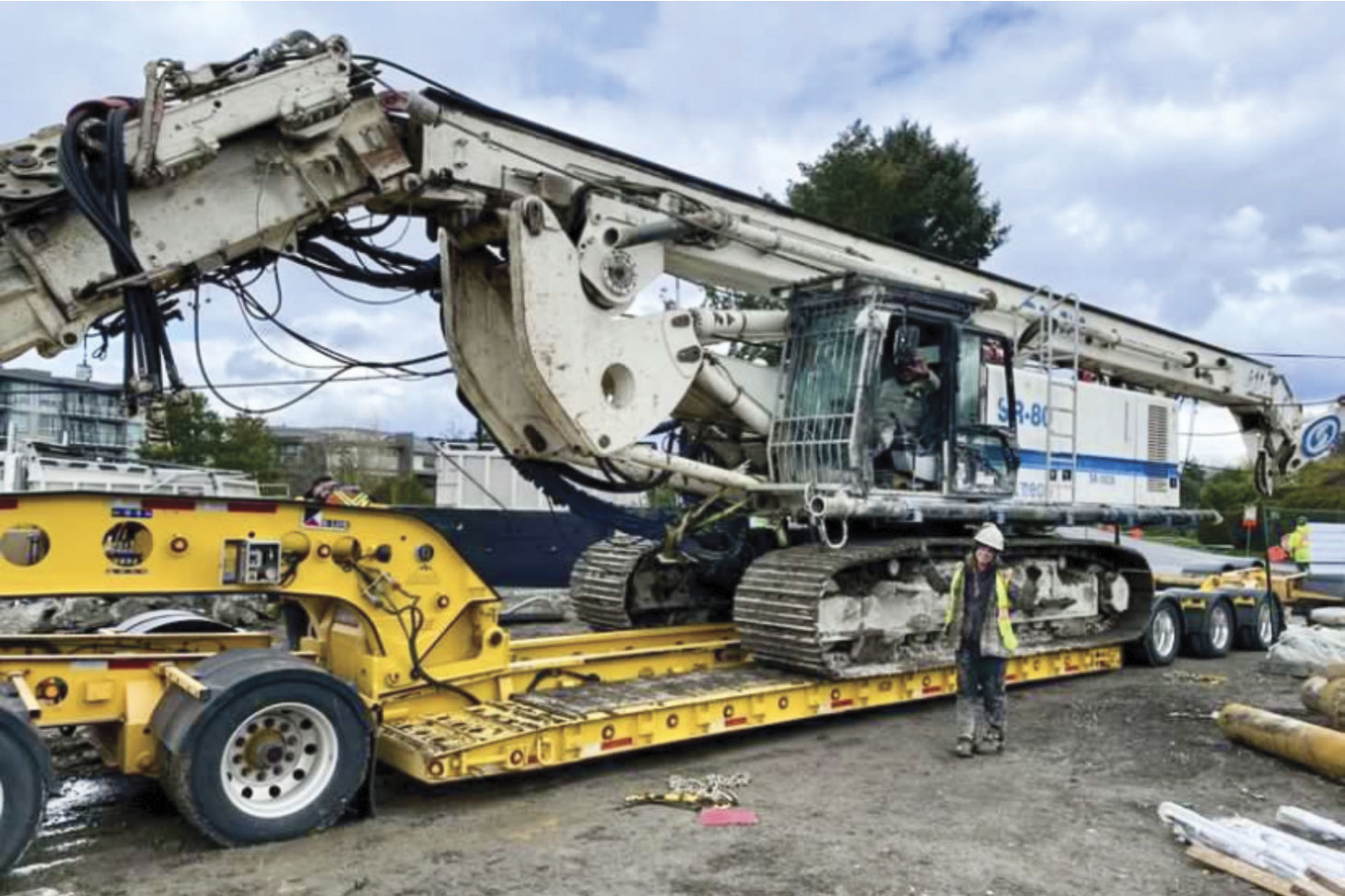 Jessica standing in front of heavy machinery