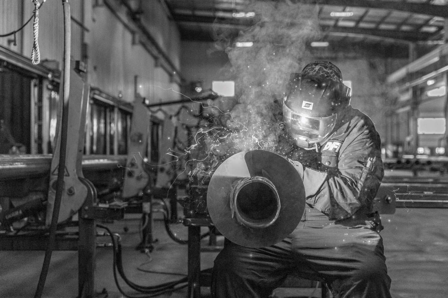 Welder performing a weld to a pile shaft