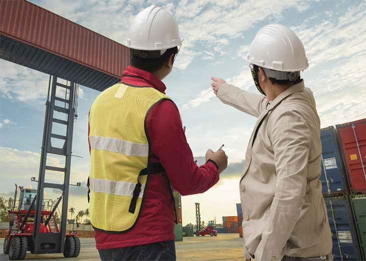 Two men in PPE on construction site