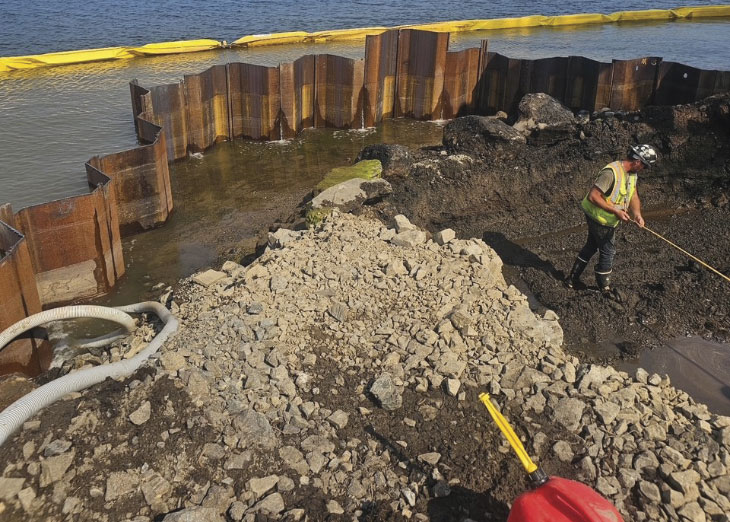 Man with shovel in construction pit