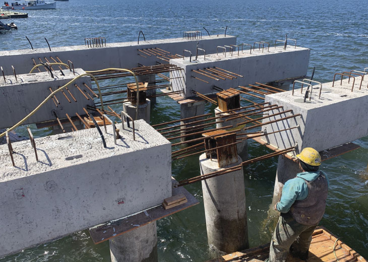 Worker overlooking pier construction