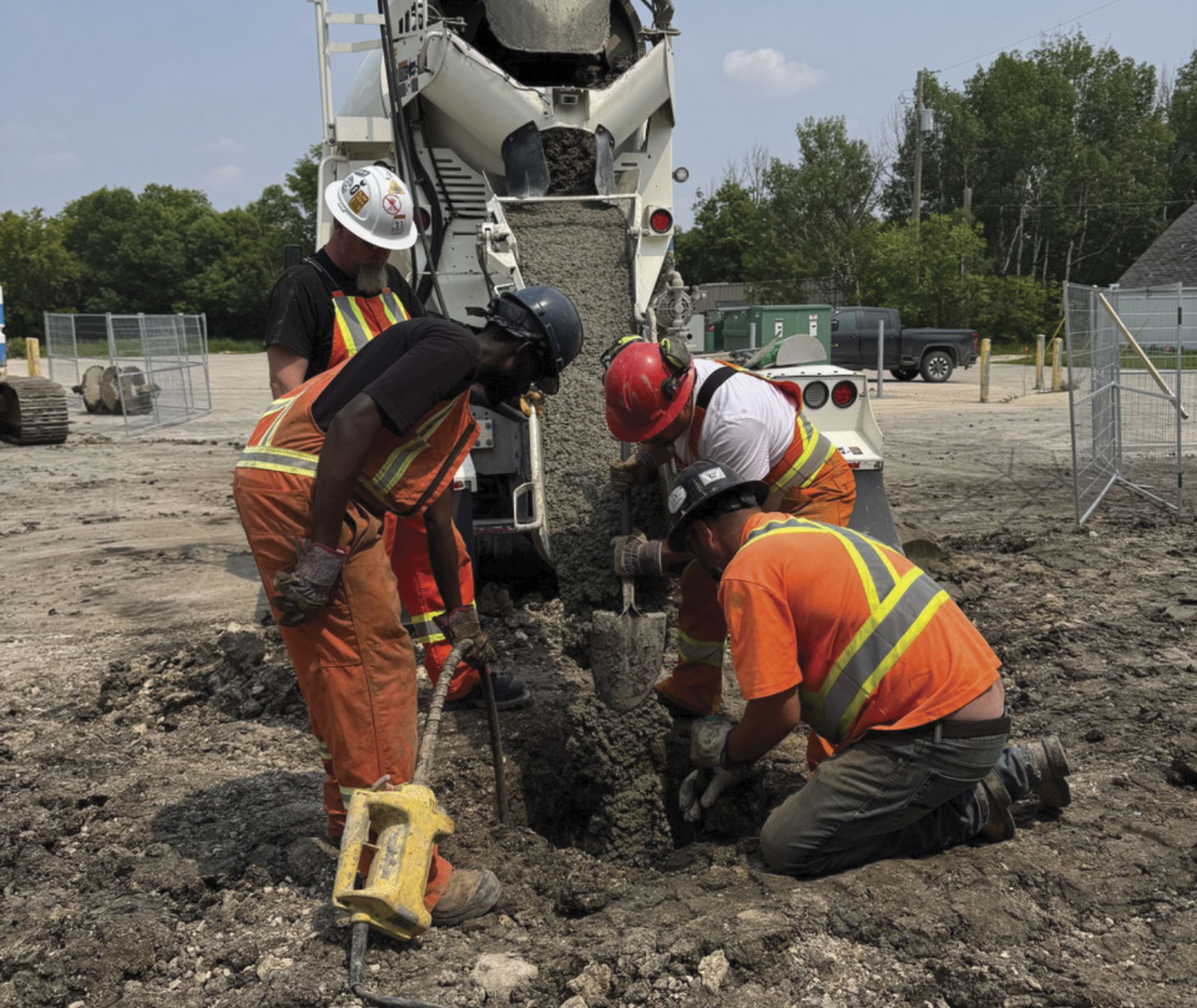Jobsite workers pouring concrete