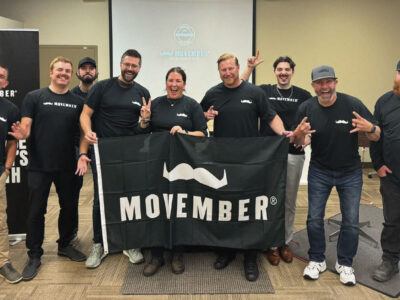Ledcor team posing for photo with Movember banner