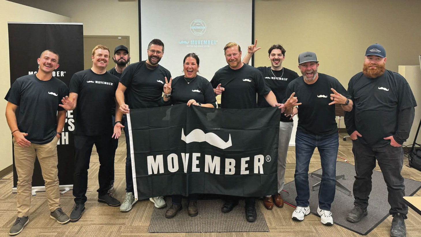 Ledcor team posing for photo with Movember banner