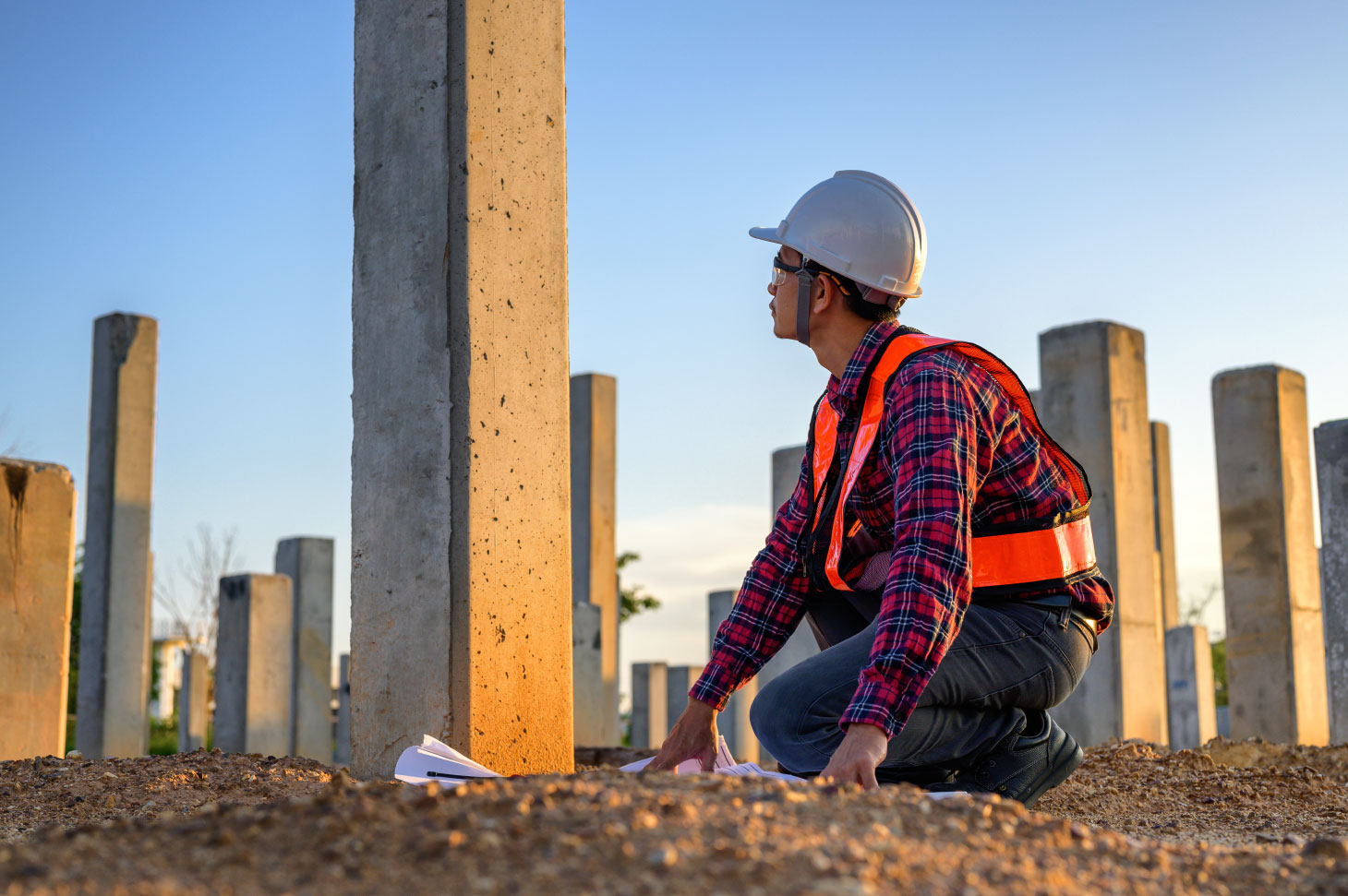 Construction engineer surveys checkpoints of concrete pile, load-bearing piles